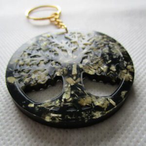 L'Arbre de Vie l'Adan Porte-clés rond en résine noire avec éclats de bois, représentant un arbre de vie détaillé. Symbole de force et de connexion avec la nature.