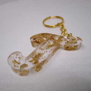 Porte-clés en résine transparente en forme de lettre "J", incrusté de feuilles d'or, avec un anneau doré et une chaîne.